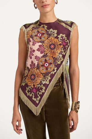 Blusa de mujer con estampado floral en tonos vino, rosa y dorado, flecos decorativos y corte asimétrico.