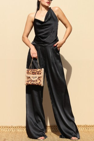 Set negro elegante con top de tirantes ajustables y pantalón ancho con bolsillos.
